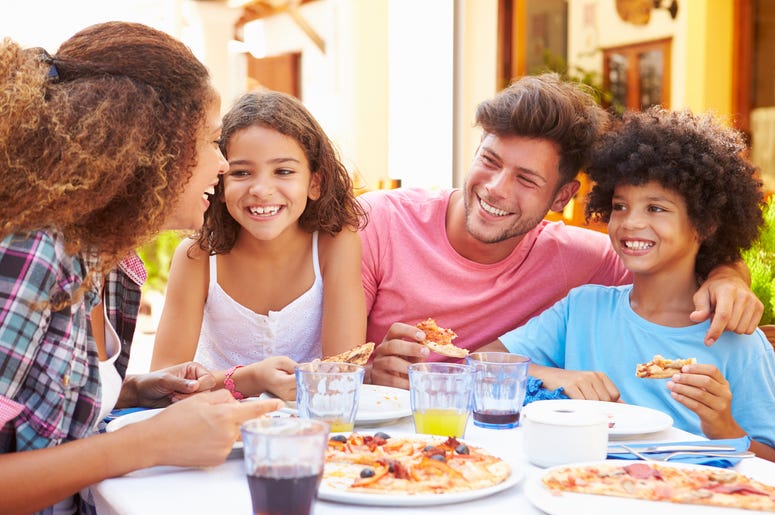 Family gathered at an outdoor restaurant to share a meal