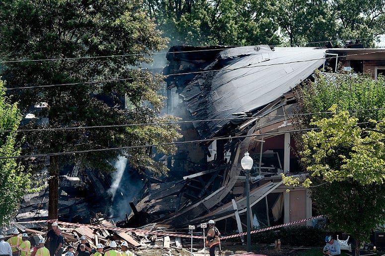Fire and rescue crews and investigators are seen at the site of an overnight explosion and fire that destroyed an apartment building in the Flower Branch Apartments complex, on August 11, 2016 in Silver Spring, Maryland Fire and rescue crews and investigators are seen at the site of an overnight explosion and fire that destroyed an apartment building in the Flower Branch Apartments complex, on August 11, 2016 in Silver Spring, Maryland