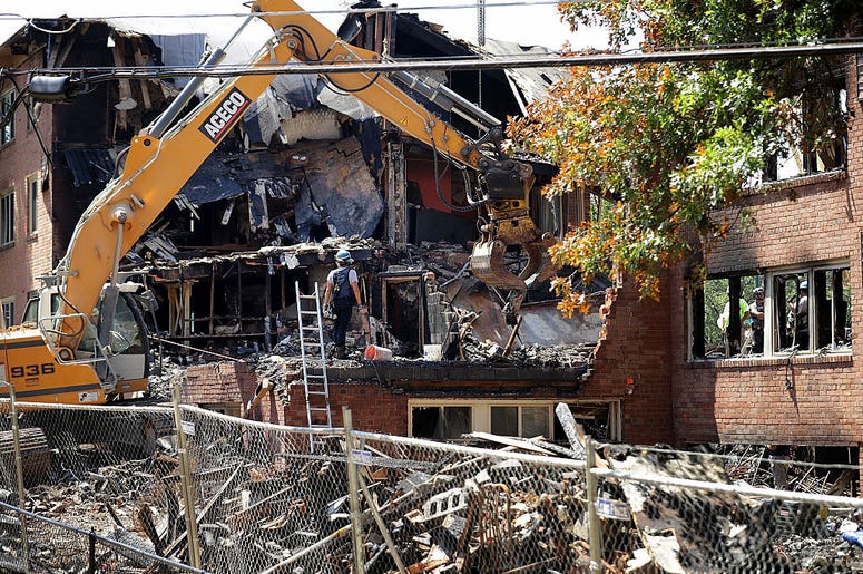 Federal, state and county investigators continue their 'brick-by-brick' inspection of the seciton of the Flower Branch Apartments that exploded and burned last week as they continue searching for one last victim August 16, 2016 in Silver Spring, Maryland. Federal, state and county investigators continue their 'brick-by-brick' inspection of the seciton of the Flower Branch Apartments that exploded and burned last week as they continue searching for one last victim August 16, 2016 in Silver Spring, Maryland.