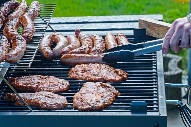 Steaks and sausages are grilled on the charcoal grill Steaks and sausages are grilled on the charcoal grill