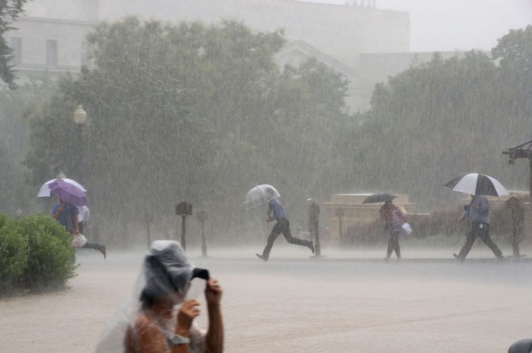 Tourist walk through heavy rain on the grounds of the US Capitol building, on July 28, 2017 in Washington, DC. Heavy rain was forcast for today and flash flood warnings were issued for certain areas. Tourist walk through heavy rain on the grounds of the US Capitol building, on July 28, 2017 in Washington, DC. Heavy rain was forcast for today and flash flood warnings were issued for certain areas.