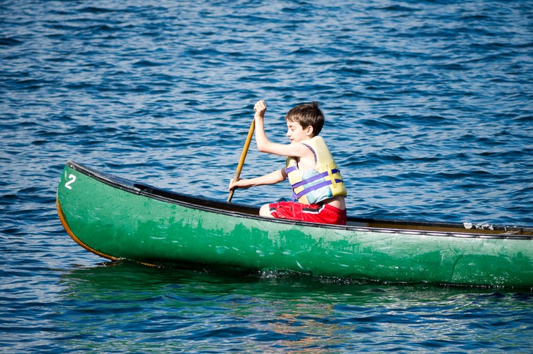 child rows in a canoe