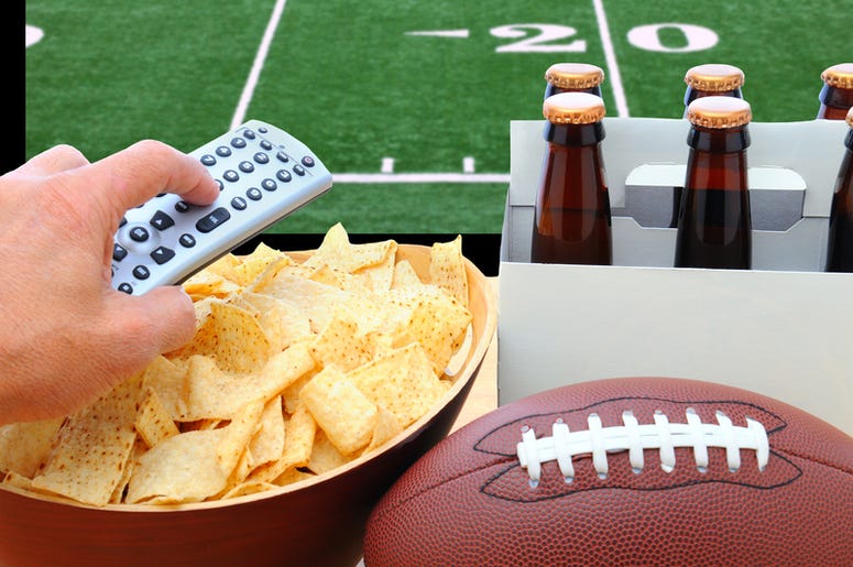 person with snacks changes television channel