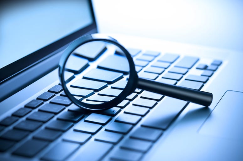 laptop computer with a magnifying glass