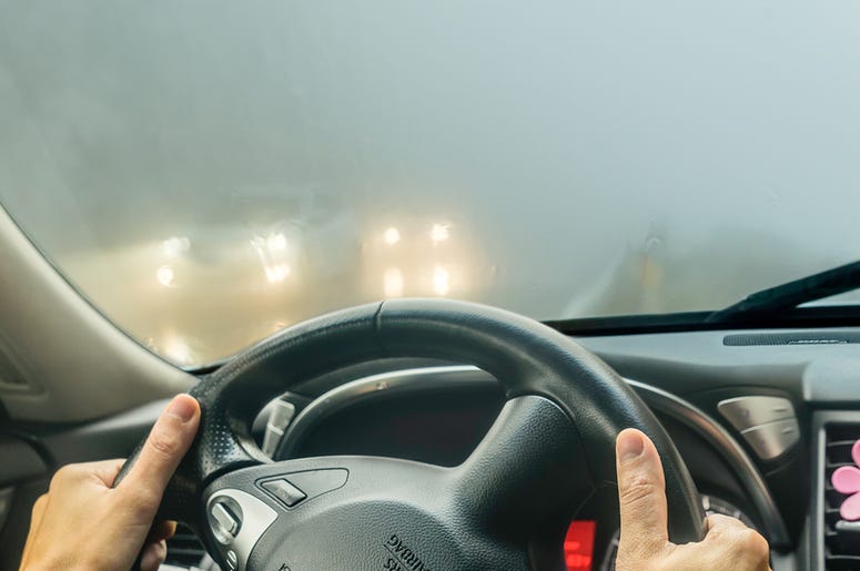 person drives car with foggy windows