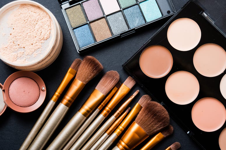 makeup and makeup brushes on a table