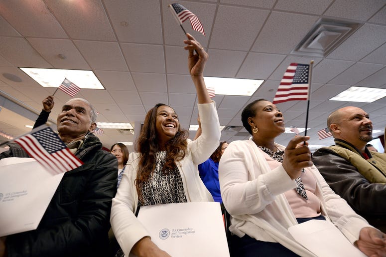 Eusebio Concepcion de Jenkins waives an american flag ceremonial playing of "America the Beautiful" during Naturalization Ceremony for new US Citizens at the offices of U.S. Citizenship and Immigration Services in New York, NY, on January 13, 2017 Eusebio Concepcion de Jenkins waives an american flag ceremonial playing of "America the Beautiful" during Naturalization Ceremony for new US Citizens at the offices of U.S. Citizenship and Immigration Services in New York, NY, on January 13, 2017
