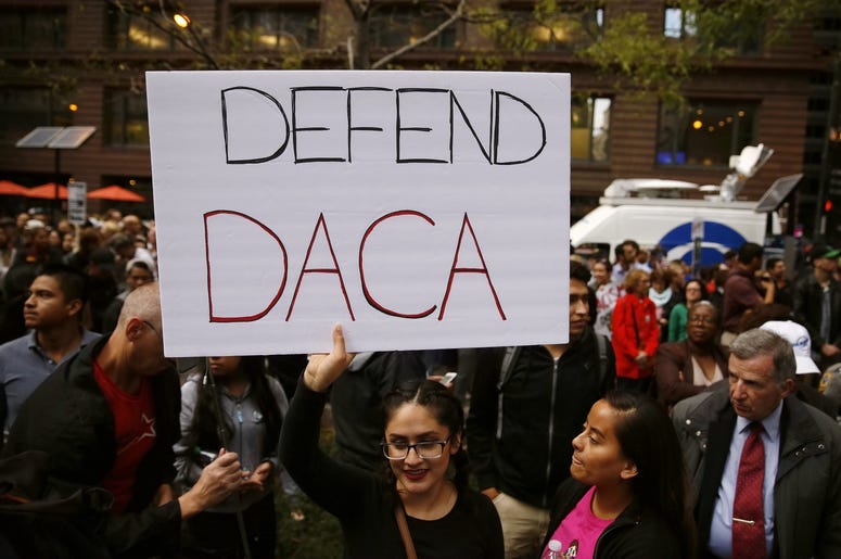 woman holding sign in support of DACA
