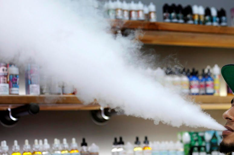 Esta foto de archivo del martes 3 de septiembre del 2019 muestra a un vendedor exhalando en una tienda de vapeo mientras fuma un cigarrillo electrónico en Maine. Esta foto de archivo del martes 3 de septiembre del 2019 muestra a un vendedor exhalando en una tienda de vapeo mientras fuma un cigarrillo electrónico en Maine.