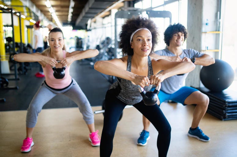 Group of healthy fit people training in gym