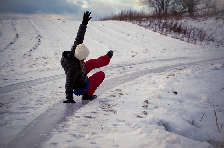 Woman falls on ice outdoors