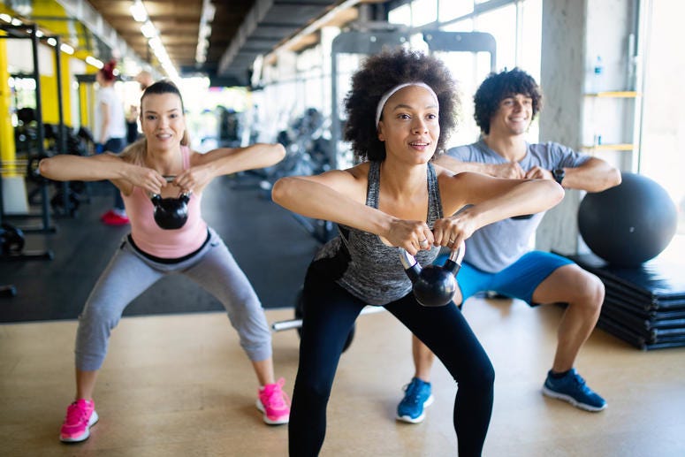 Group of healthy fit people training in gym