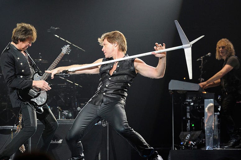 Bon Jovi guitarist Richie Sambora, singer Jon Bon Jovi and keyboardist David Bryan perform at the MGM Grand Garden Arena March 19, 2011 in Las Vegas, Nevada. Bon Jovi guitarist Richie Sambora, singer Jon Bon Jovi and keyboardist David Bryan perform at the MGM Grand Garden Arena March 19, 2011 in Las Vegas, Nevada.