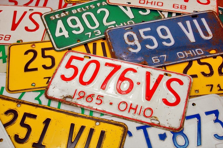 Various vintage Ohio license plates from the late 60's and early 70's arranged in a collage.