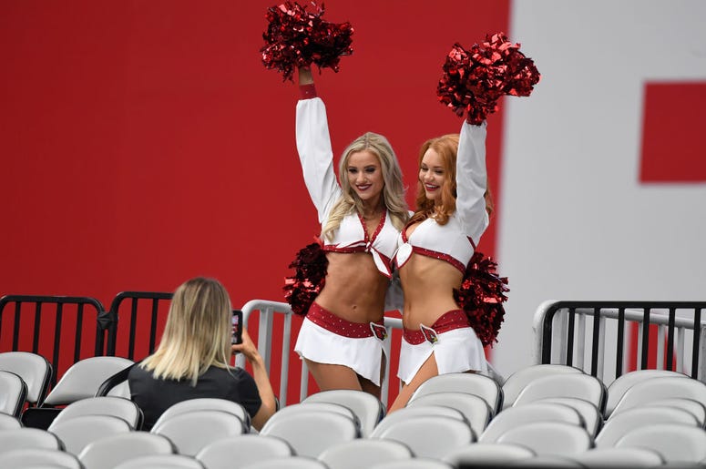 Two Arizona Cardinals cheerleaders take photos in the stands prior to a game against the Detroit Lions at State Farm Stadium on September 08, 2019 in Glendale, Arizona. Two Arizona Cardinals cheerleaders take photos in the stands prior to a game against the Detroit Lions at State Farm Stadium on September 08, 2019 in Glendale, Arizona.