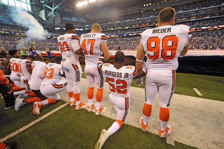 The Cleveland Browns team stand and kneel during the National Anthem The Cleveland Browns team stand and kneel during the National Anthem