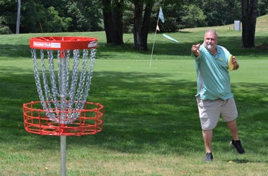 Course designer Jeff Carter makes a throw at the new Springbrook Disc G1.JPGolf Course, which opened earlier this month. springbrook disc golf 1.JPG
