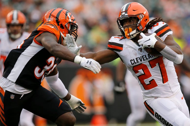 Cleveland Browns running back Kareem Hunt (27) stiff arms Cincinnati Bengals strong safety Shawn Williams (36) on a carry in the fourth quarter of the NFL Week 17 game between the Cincinnati Bengals and the Cleveland Browns at Paul Brown Stadium in downto
