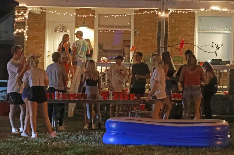 Off-campus porch and yard parties near the Ohio State University campus in Columbus were packed Thursday, August 20, 2020. Few masks were visible even though the COVID-19 pandemic is rampant. A mix of online and in-person classes begin August 25, 2020 at