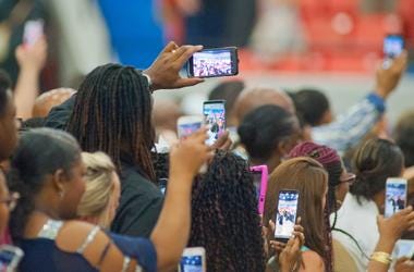 Relatives and friends take photographs with their Relatives and friends take photographs with their smart phosmart phones of graduating seniors marching into Broadbent Arena during the school's commencement exercises. 12 June 2019 0612ferncreekgrad011 Drl