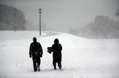 Alex Molnar, left, and his wife Barbara Lindquist walk through McKinley Marina to enjoy the first major snow storm of the season. While most may be dreading this unwelcome fall storm, It s a beautiful day, said Molnar. Mjs Wild Snow 1