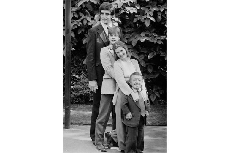 Actor Peter Mayhew, Mark Hamill, Carrie Fisher (1956 - 2016), Kenny Baker (1934 - 2016), co-stars in the first Star Wars trilogy, UK, 20th May 1980. Actor Peter Mayhew, Mark Hamill, Carrie Fisher (1956 - 2016), Kenny Baker (1934 - 2016), co-stars in the first Star Wars trilogy, UK, 20th May 1980.