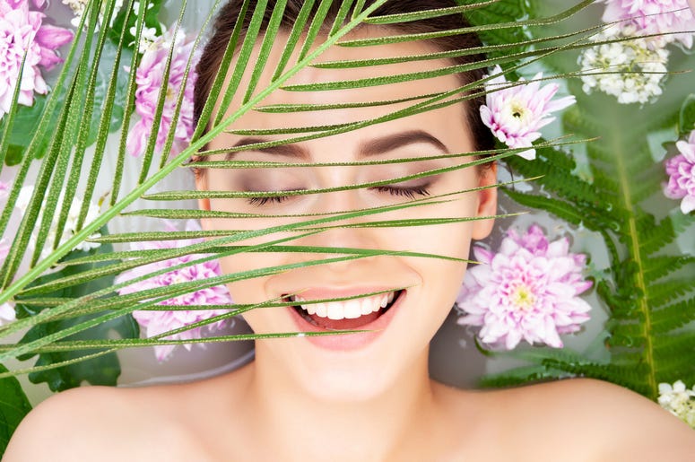 Woman surrounded by flowers