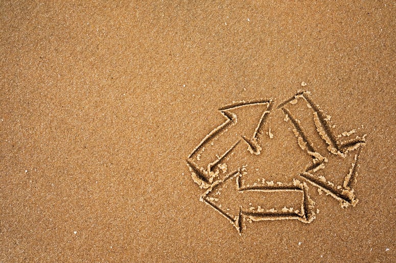 Recycle symbol on beach