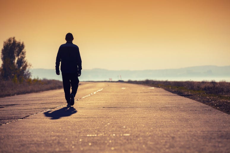 man walking on country road man walking on country road