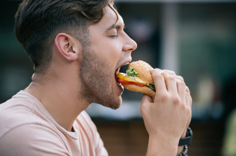 guy eating a burger guy eating a burger