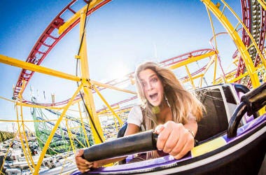 women riding rollercoaster woman riding rollercoaster