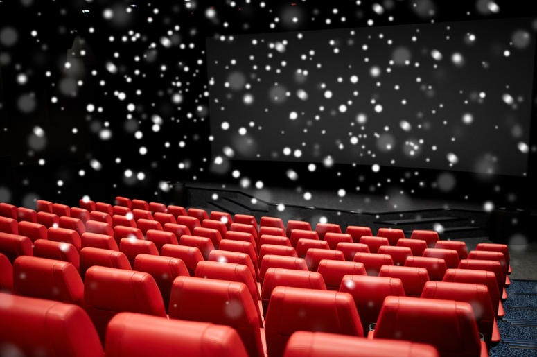 Entertainment and leisure concept - movie theater or cinema empty auditorium with red seats over snowflakes Entertainment and leisure concept - movie theater or cinema empty auditorium with red seats over snowflakes