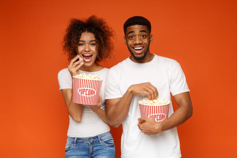 Two People Eating Popcorn