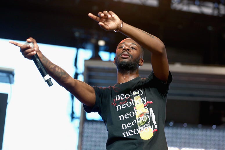 Fans and other celebs drag Goldlink over Mac Miller comments. Goldlink is pictured waving his hands during a performance.