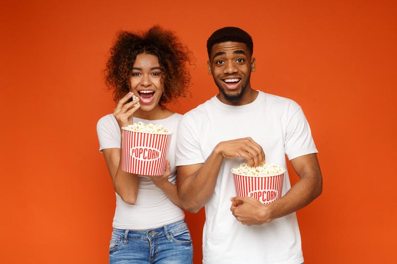 Two People Eating Popcorn