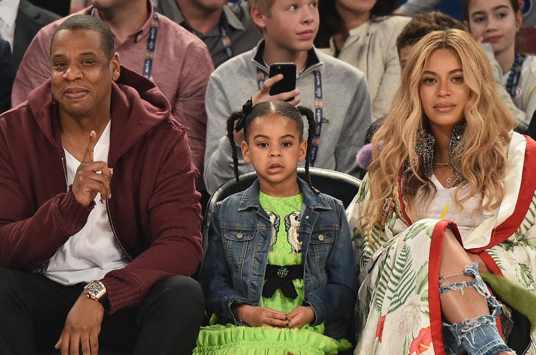 Journalists were called out for criticizing Blue Ivy‘s looks. Jay Z, Blue Ivy Carter and Beyoncé sit courtside at a basketball game.