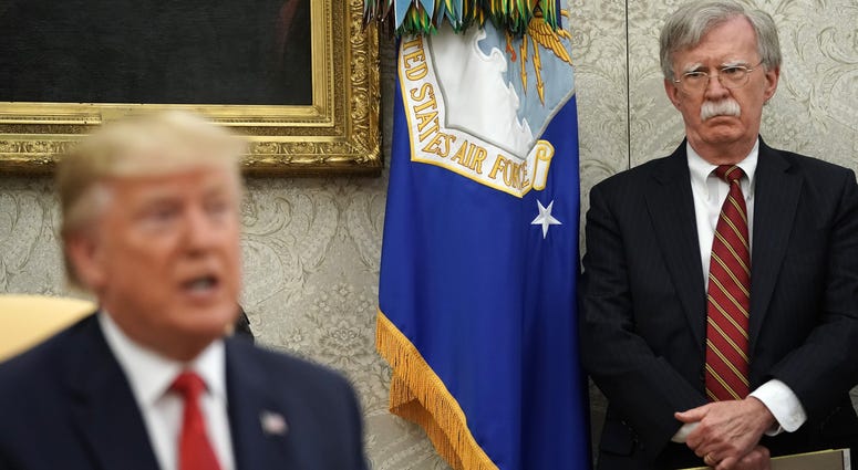 WASHINGTON, DC - JULY 18: White House National Security Advisor John Bolton (R) listens to U.S. President Donald Trump as he and Dutch Prime Minister Mark Rutte talk to reporters in the Oval Office at the White House July 18, 2019 in Washington, DC.