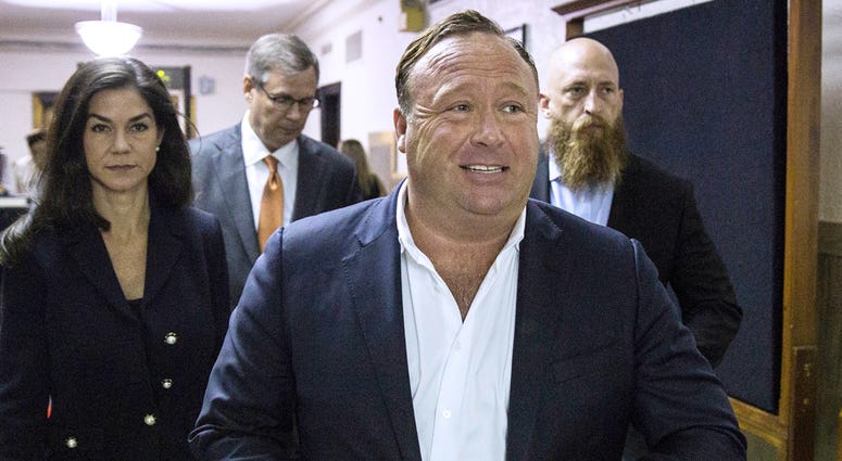 FILE - In this April 17, 2017, file photo, "Infowars" host Alex Jones arrives at the Travis County Courthouse in Austin, Texas. Jones filed a motion Friday, July 20, 2018, to dismiss a defamation lawsuit filed by families of so