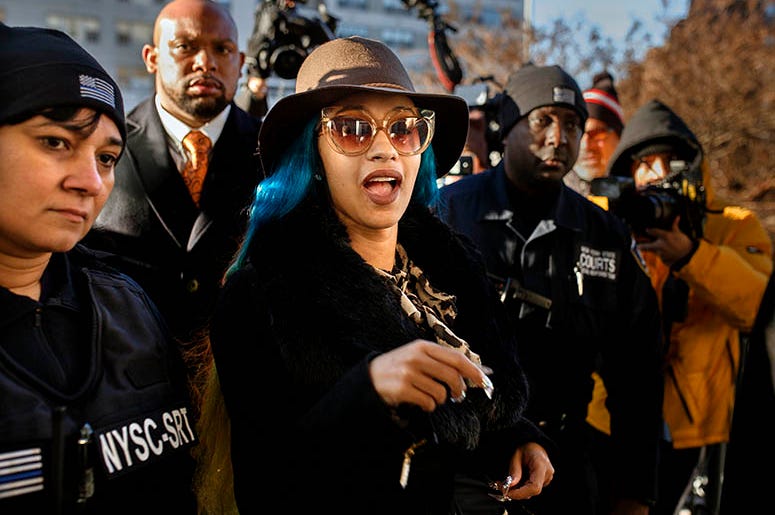 This Dec. 7, 2018 file photo shows Rapper Cardi B, center, arriving at Queens County Criminal Court in New York on charges related to a brawl at a New York strip club. Cardi B is trying to clarify herself after a video surfaced online where the rapper sai Cardi_B_AP_Photo_Andrew_Kudacki_File