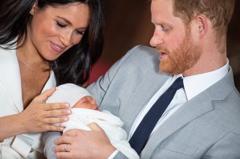 WINDSOR, ENGLAND - MAY 08: Prince Harry, Duke of Sussex and Meghan, Duchess of Sussex, pose with their newborn son Prince Archie Harrison Mountbatten-Windsor during a photocall in St George's Hall at Windsor Castle on May 8, 2019 in Windsor, England. The WINDSOR, ENGLAND - MAY 08: Prince Harry, Duke of Sussex and Meghan, Duchess of Sussex, pose with their newborn son Prince Archie Harrison Mountbatten-Windsor during a photocall in St George's Hall at Windsor Castle on May 8, 2019 in Windsor, England. The