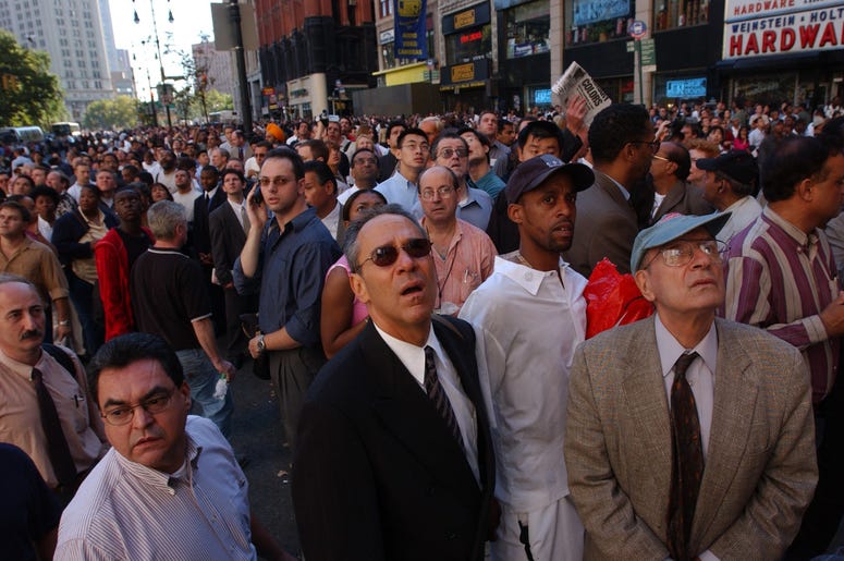 People watch World Trade Center burn September 11, 2001 after two hijacked airplanes slammed into the twin towers in New York City. People watch World Trade Center burn September 11, 2001 after two hijacked airplanes slammed into the twin towers in New York City. (Photo by Spencer Platt/Getty Images)