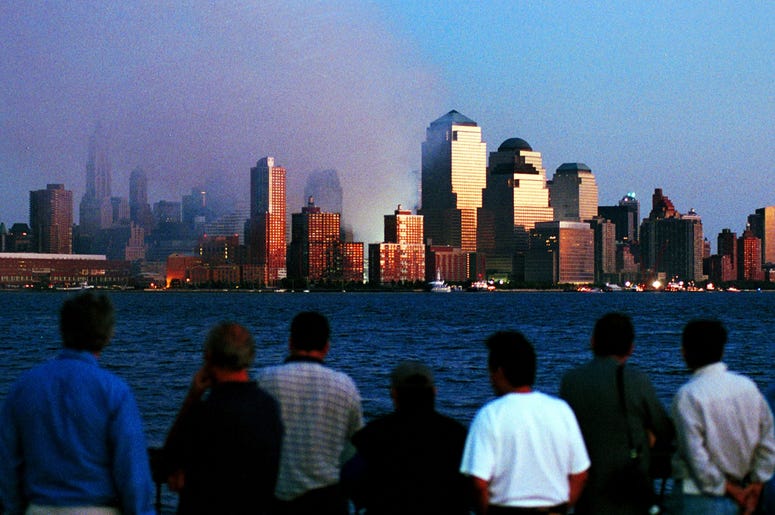 People watch smoke emit from the former site of the World Trade Center September 12, 2001 in Hoboken, N.J. Smoke filled the air all over lower Manhattan in the aftermath of Tuesday's terrorist attack and destruction of the World Trade Center. (Photo by Ch People watch smoke emit from the former site of the World Trade Center September 12, 2001 in Hoboken, N.J. Smoke filled the air all over lower Manhattan in the aftermath of Tuesday's terrorist attack and destruction of the World Trade Center. (Photo by Ch