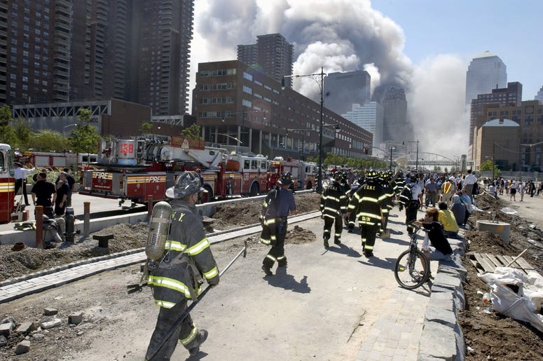 Fireman heading south on the West Side Highway towards the remains of the World Trade Center where smoke continued hours after the colapse. Streets of lower Manhattan with fireman, police, and rescue crews after the colapse of the World Trade Center after Fireman heading south on the West Side Highway towards the remains of the World Trade Center where smoke continued hours after the colapse. Streets of lower Manhattan with fireman, police, and rescue crews after the colapse of the World Trade Center after