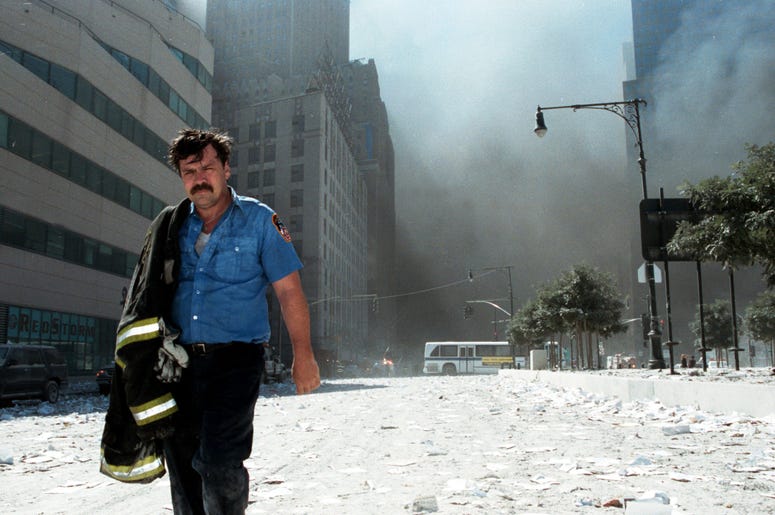 NEW YORK - SEPTEMBER 11: An unidentified New York City firefighter walks away from Ground Zero after the collapse of the Twin Towers September 11, 2001 in New York City. The World Trade Center's Twin Towers and the Pentagon were attacked by terrorists usi NEW YORK - SEPTEMBER 11: An unidentified New York City firefighter walks away from Ground Zero after the collapse of the Twin Towers September 11, 2001 in New York City. The World Trade Center's Twin Towers and the Pentagon were attacked by terrorists usi