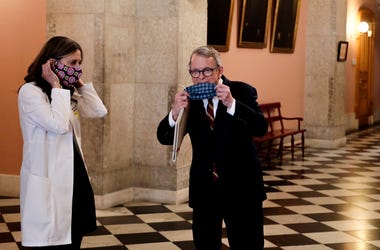 Apr 6, 2020; Columbus, OH, USA; Dr. Amy Acton (left) director of the Ohio Department of Health, and Ohio Gov. Mike DeWine (right) pose with their homemade masks following a press conference on the State of Ohio's response to the ongoing COVID-19 pandemic
