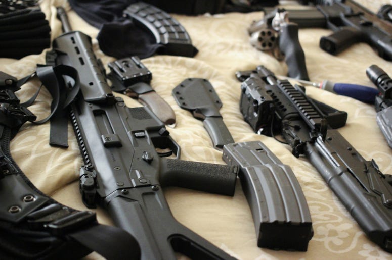 Guns On A Bed assorted guns on a bed