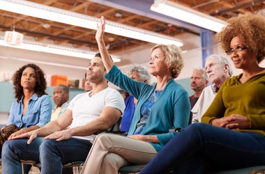 Woman Raise Hand Town Hall