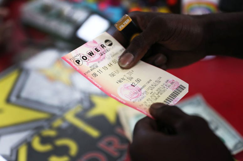 man holding powerball ticket