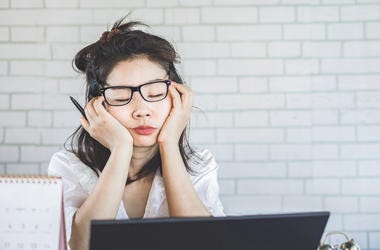 Woman Tired At Desk woman tired at desk