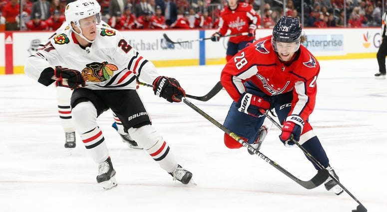 Blackhawks defenseman Adam Boqvist, left, defends against Capitals winger Brendan Leipsic (28). Blackhawks defenseman Adam Boqvist, left, defends against Capitals winger Brendan Leipsic (28).